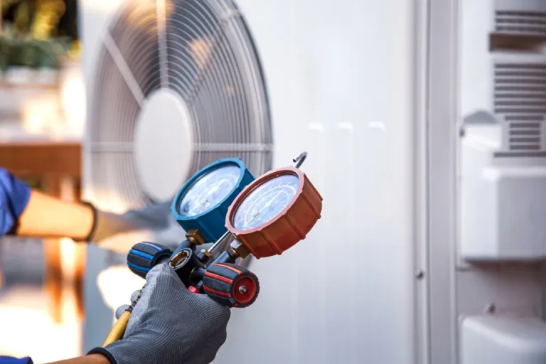 Air Conditioning technician using measuring manifold gauge